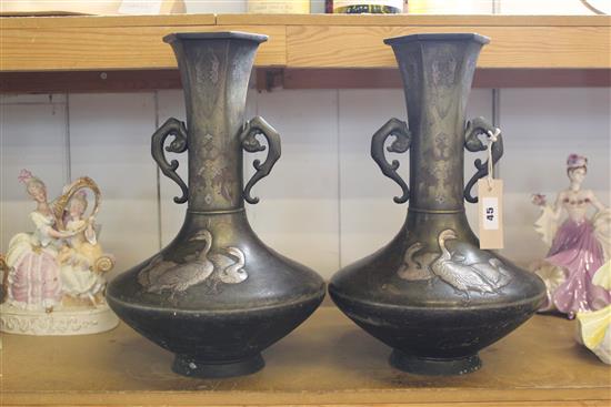 Pair of Japanese Meiji period bronze narrow-neck vases, with twin handles and silvered decoration of geese